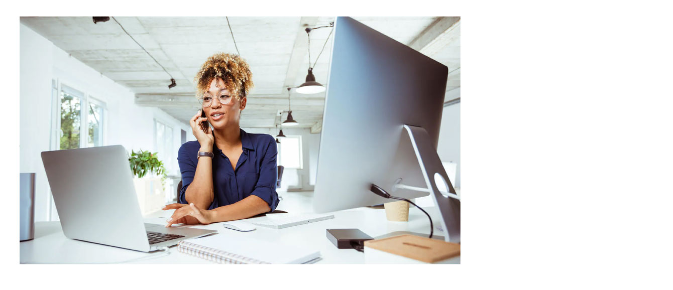 Image of woman sitting in office on the phone