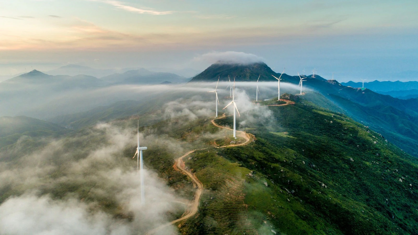 Image of windmills on a mountain with clouds